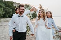 beautiful-bride-groom-having-their-wedding-with-guests-beach